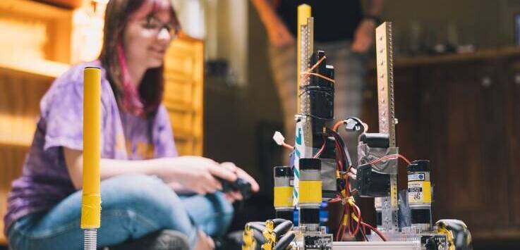 Salem Academy student testing her custom robot