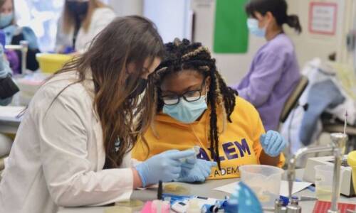 Salem Academy students in lab with gloves masks and equipment