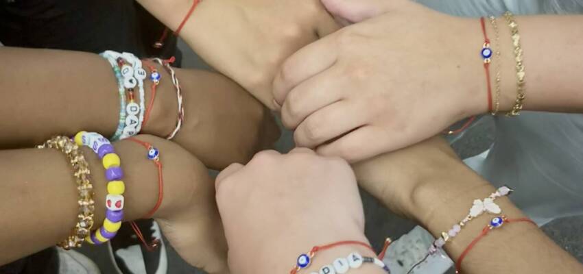 students showing off friendship bracelets