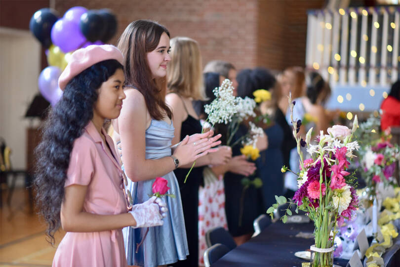 two students getting flowers during family weekend