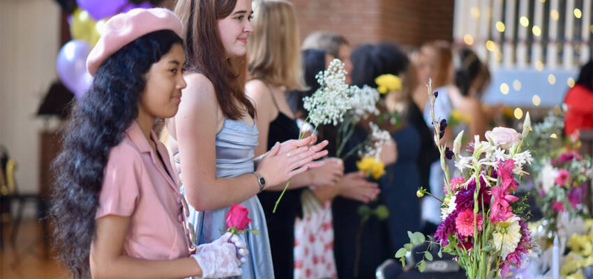 two students getting flowers during family weekend