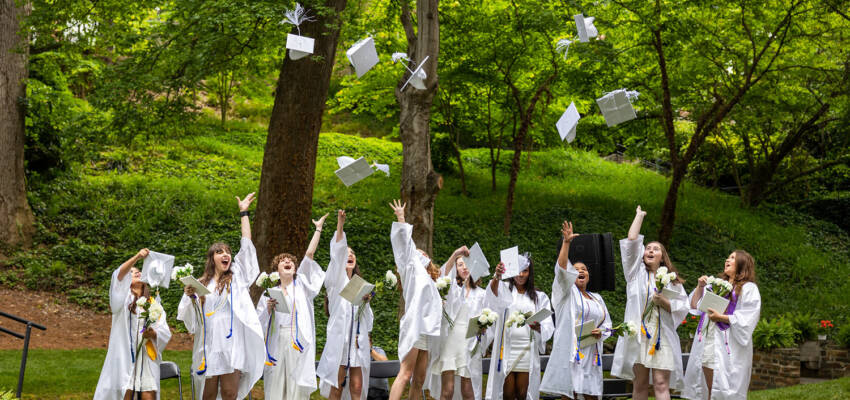 graduates toss their caps