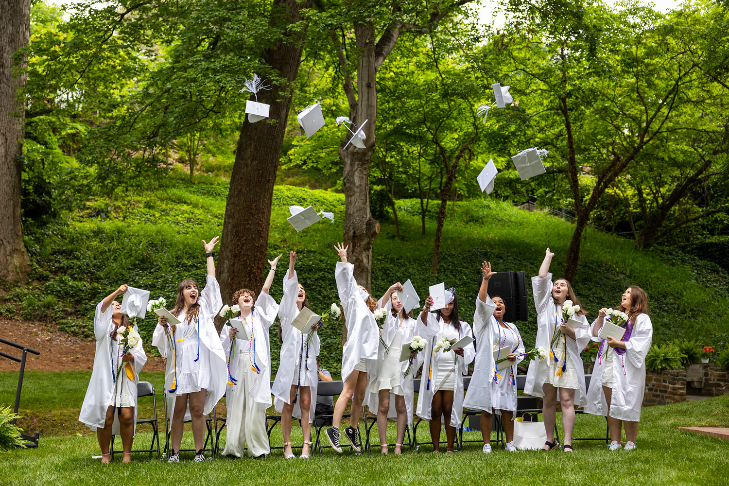 graduates toss their caps