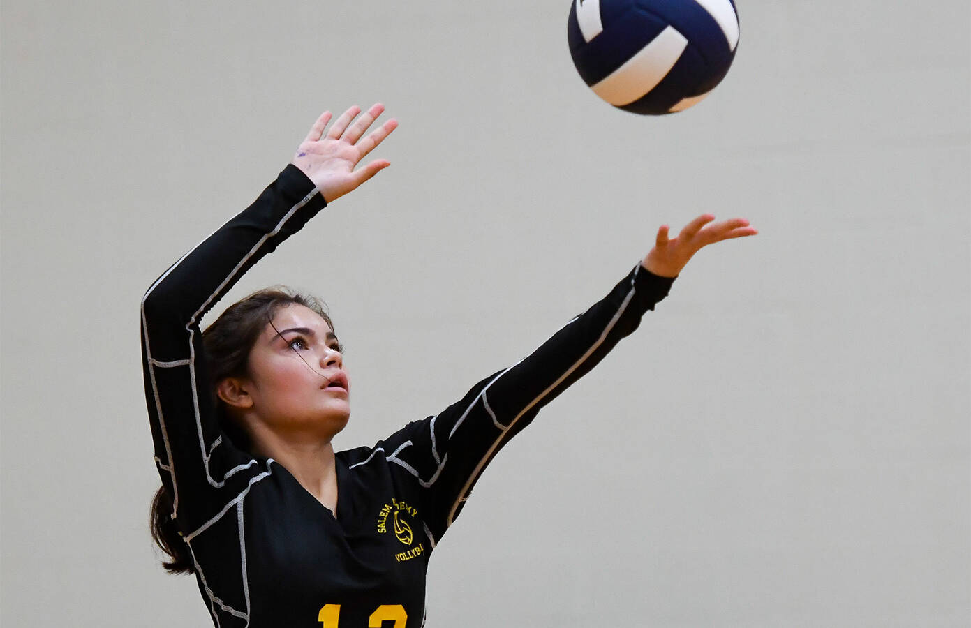 Salem volleyball player serves the ball
