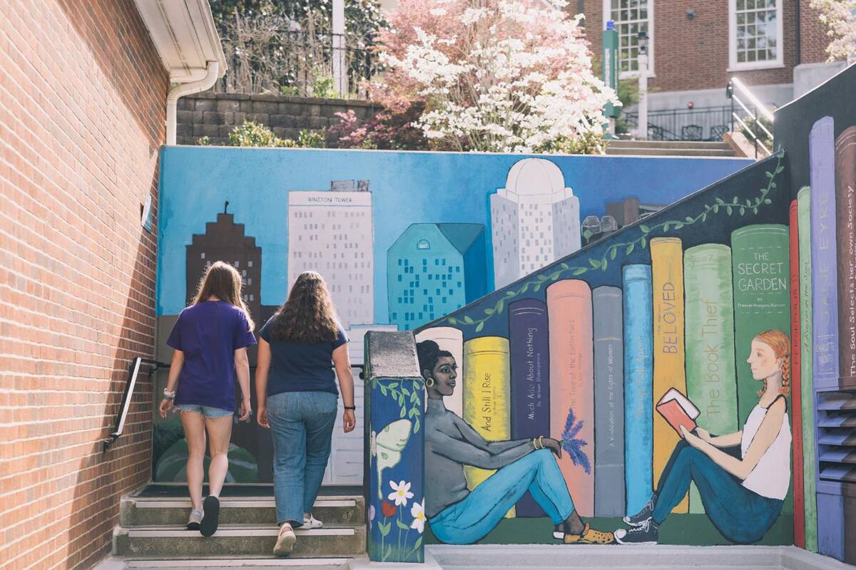 students walking up painted staircase