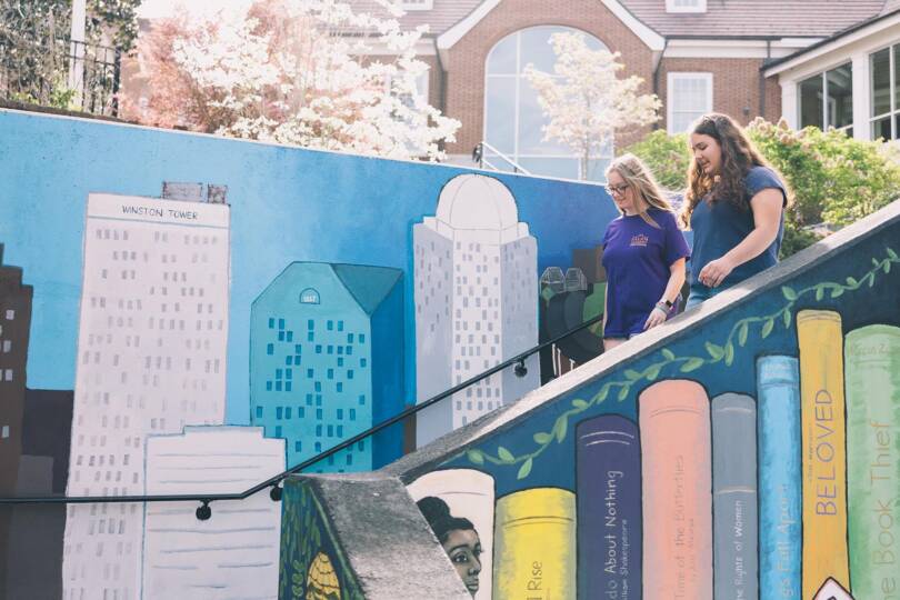 students walking down painted staircase
